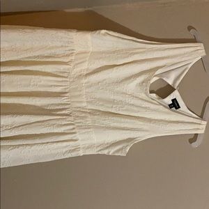 White dress white flowers embroidered onto it